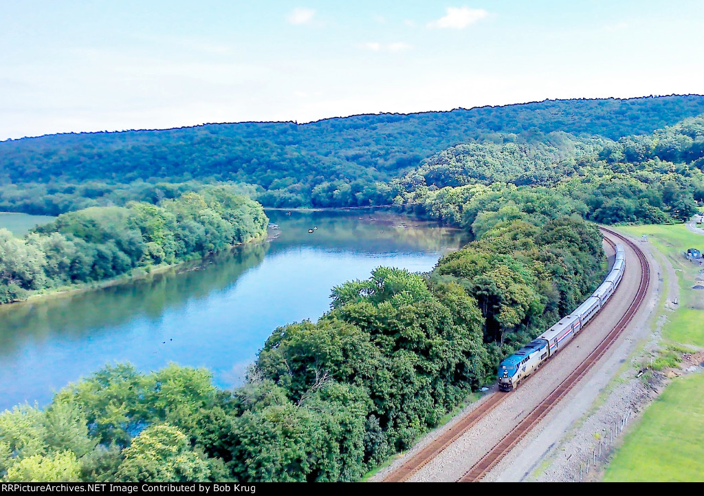 The westbound Pennsylvanian glides along the south bank of the Juniata River